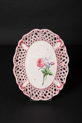 a close up of a plate with a flower on it