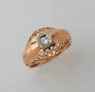 a close up of a gold ring with a diamond in the center