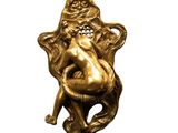 an image of a gold figurine of a woman sitting on a chair