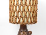 a lamp that has a woven shade on top of it