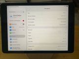 someone is holding a tablet computer with a lot of notifications on the screen