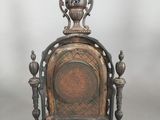 an image of a metal clock sitting on top of a table