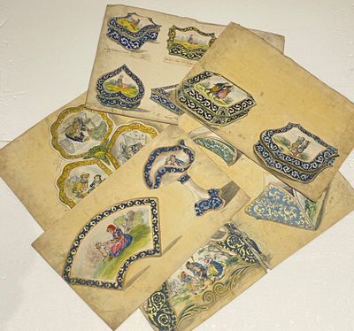 several pieces of paper with different designs on them sitting on a table