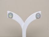 a pair of earrings that are on a white stand