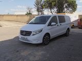 the white van is parked on the side of the road