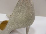 a close up of a pair of silver shoes on a table