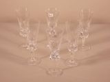 several empty wine glasses are lined up on a table