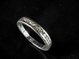 a close up of a diamond ring on a black cloth