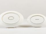 two white plates sitting on top of a white table