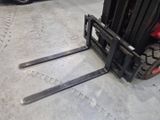 a fork lifter that is parked in a garage