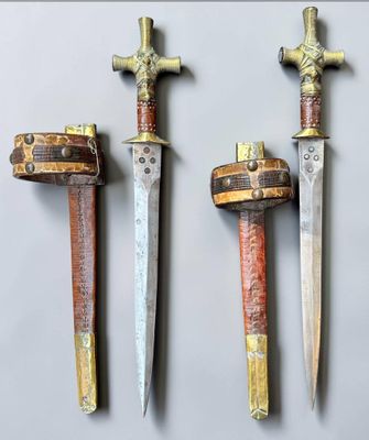 three different types of swords are displayed on a white surface