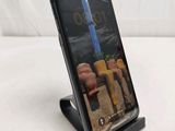 an image of a cell phone on a stand on a white surface