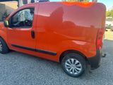 an orange van parked in a parking lot next to a building