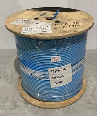 a close up of a spool of blue wire on a wooden spool