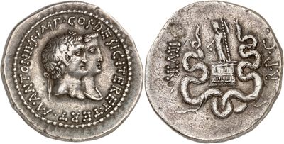 a silver coin with an image of a woman and a dragon on it
