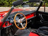 a red and black car with a steering wheel and dashboard