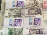many different bills of different colors and shapes on the table
