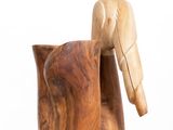 a wooden duck that is sitting next to a wooden cup