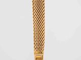 a close up of a gold watch on a white background