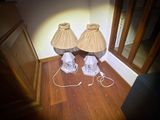 two lamps that are sitting on a hard wood floor