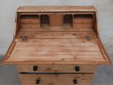 a close up of a wooden desk with drawers on top of it