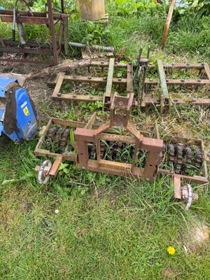 a blue tractor that is sitting in the grass