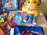 a lot of children ' s backpacks and toys on the table