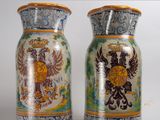pair of decorative vases sitting on top of a white surface