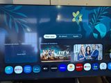 a flat screen tv sitting on a stand in a living room