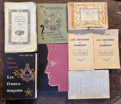 several old books are sitting on top of a wooden table