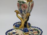 a picture of a vase and two plates on a white surface