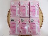six boxes of pink and white toothbrushes sitting on top of a wicker basket