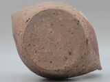 a close up of a clay object on a gray surface