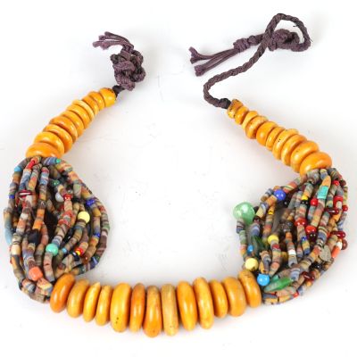 a close up of a bracelet with beads on a white surface