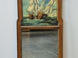 un miroir sur lequel est représenté un bateau