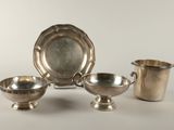 three pieces of silverware sitting on top of a white table