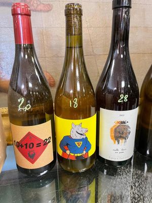 several bottles of wine are lined up on a glass table