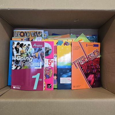 many books in a cardboard box on the table