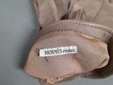 a glove that has a label on it that says hermes paris