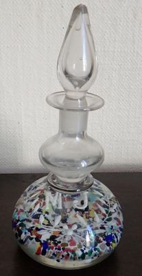 a small glass vase with a glass top sitting on a table