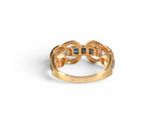 a close up of a gold ring with blue stones on it