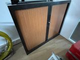 a cabinet with a tv on top of it in a room