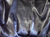 a close up of a black satin material with a pattern