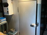 a refrigerator in a room with a lot of boxes on the floor