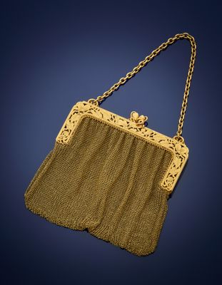 an antique gold mesh purse with a chain handle