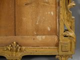 a gold frame with a clock on top of it