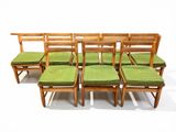 six chairs with green cushions on them in a row