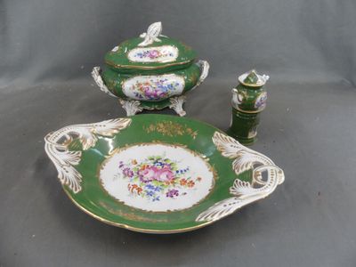 a green and white plate with a bowl and a candle holder