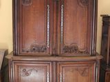 a large wooden cabinet in the corner of a room