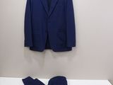 a blue suit and a pair of blue pants on a bed